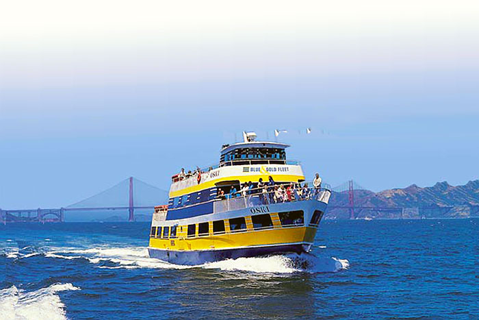 A boat with passengers on it in the ocean.