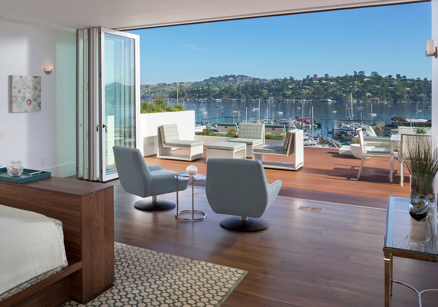 A living room with large windows overlooking the water.