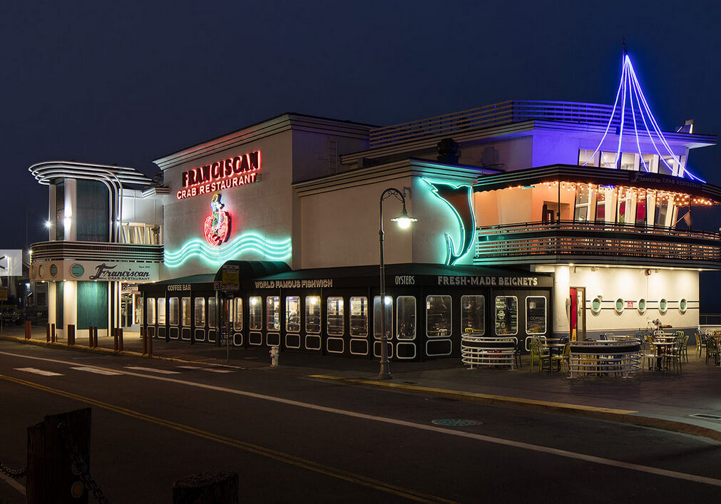 A large building with lights on the outside of it