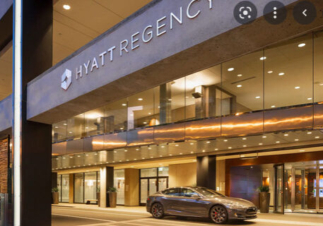 A car parked in front of the hyatt regency.