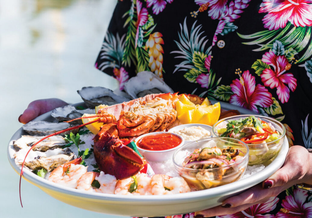 A plate of food with lobster and shrimp.